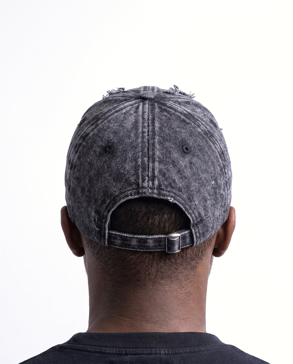 Model wearing the Denaro Denim Cap in washed black denim, seen from behind