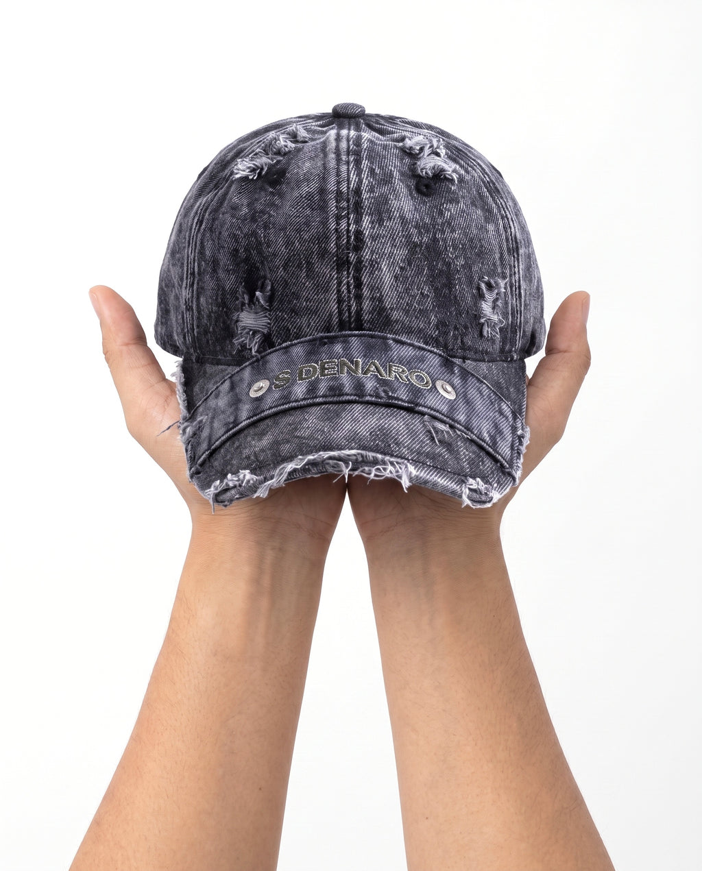 Denaro Denim Cap in washed black denim held in hand