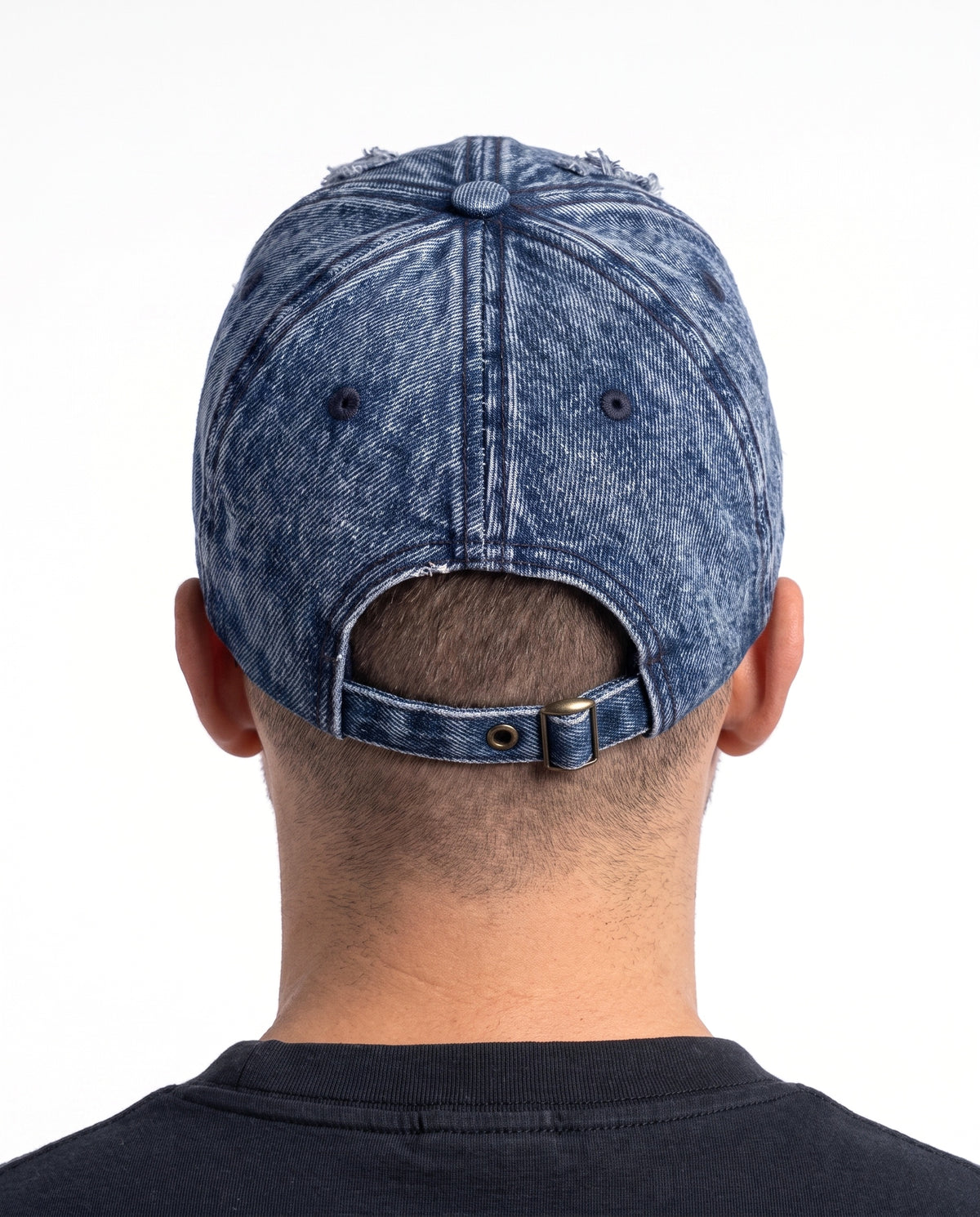 Model wearing the Denaro Denim Cap in washed blue denim, seen from behind