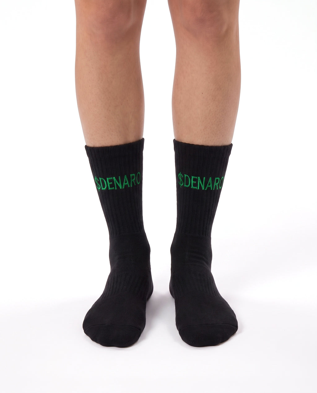 Model wearing Denaro crew socks in black, standing