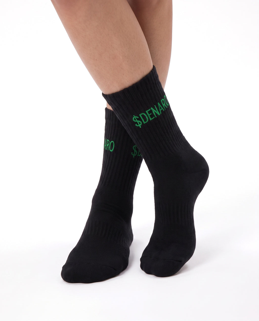 Model wearing Denaro crew socks in black, seated