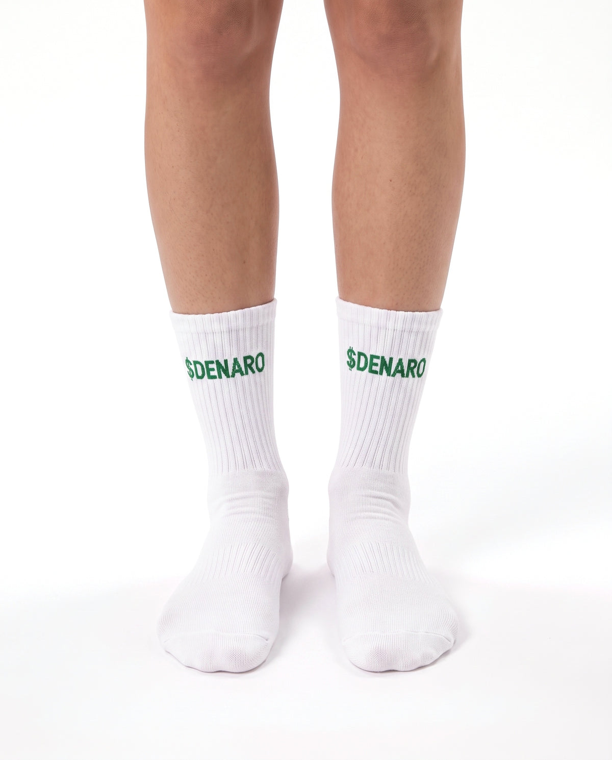 Model wearing Denaro crew socks in white, standing